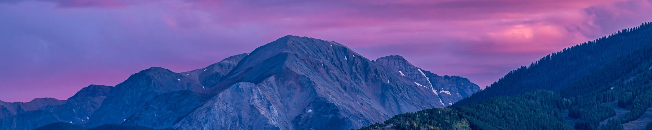 Pink purple colorful sunset in Aspen, Colorado with Rocky mountains of Buttermilk ski slope mountain in autumn fall with twilight sunset.